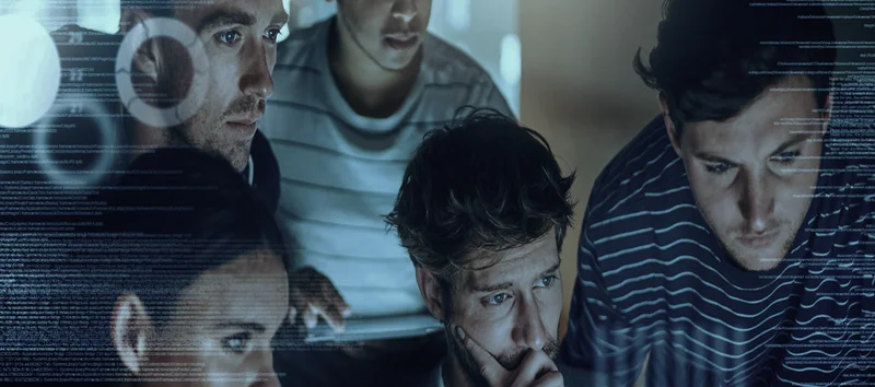 Team collaborating in front of a screen