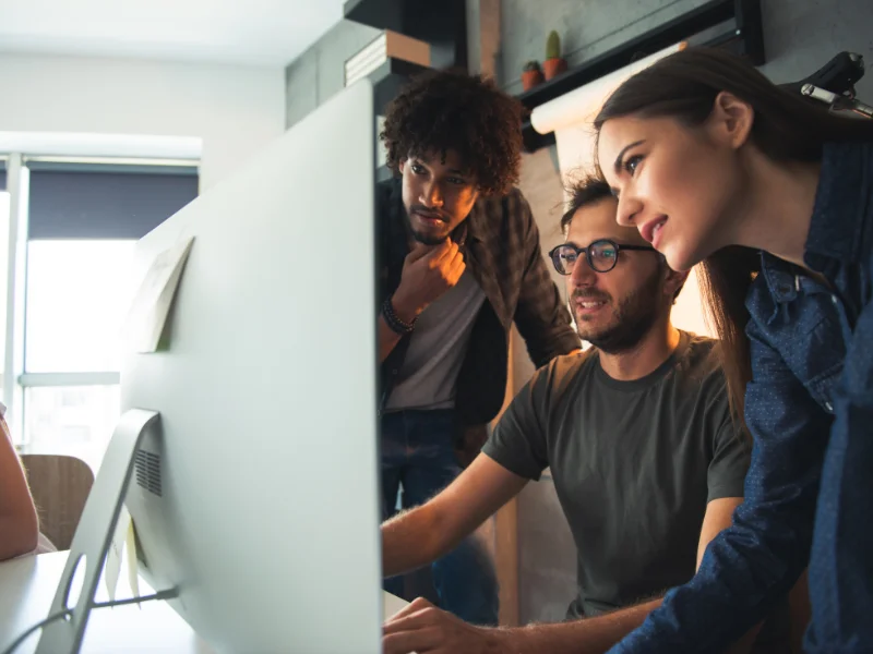 Two engineers collaborating while planning a CI/CD pipeline